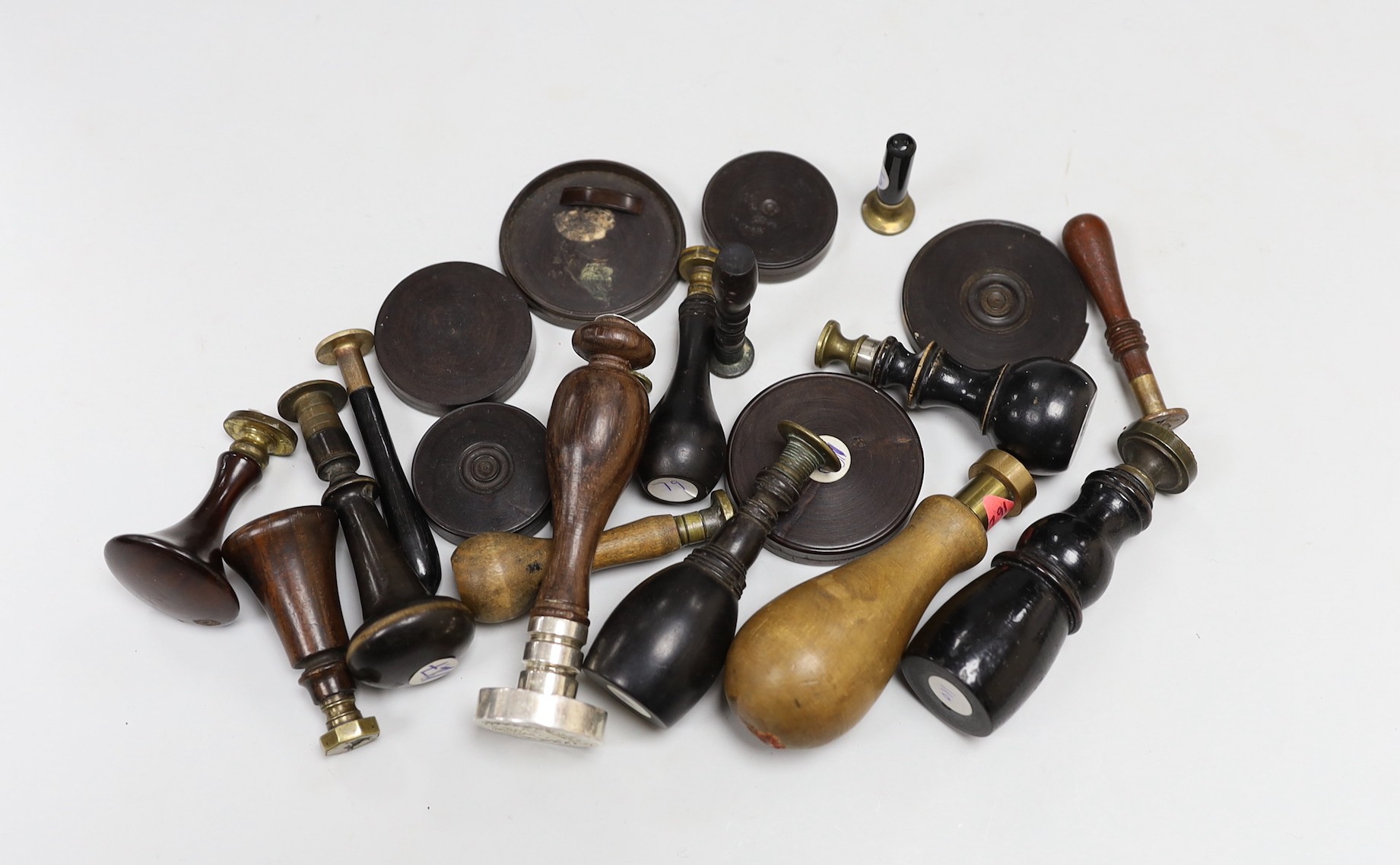 A selection of wood-mounted desk seals, 19th/20th century, together with some treen cased wax armorial samples, and other curios